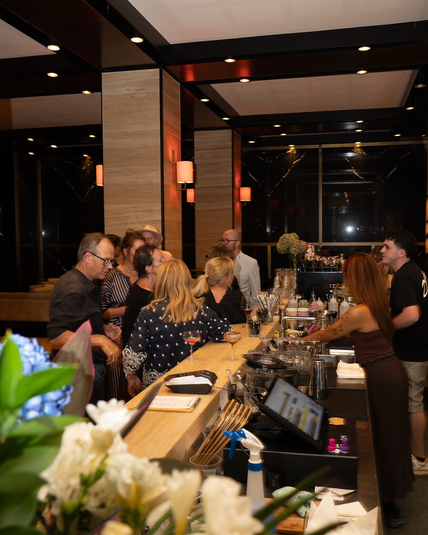 Guests gathered along the bar during a private function at Deschlers on Queen