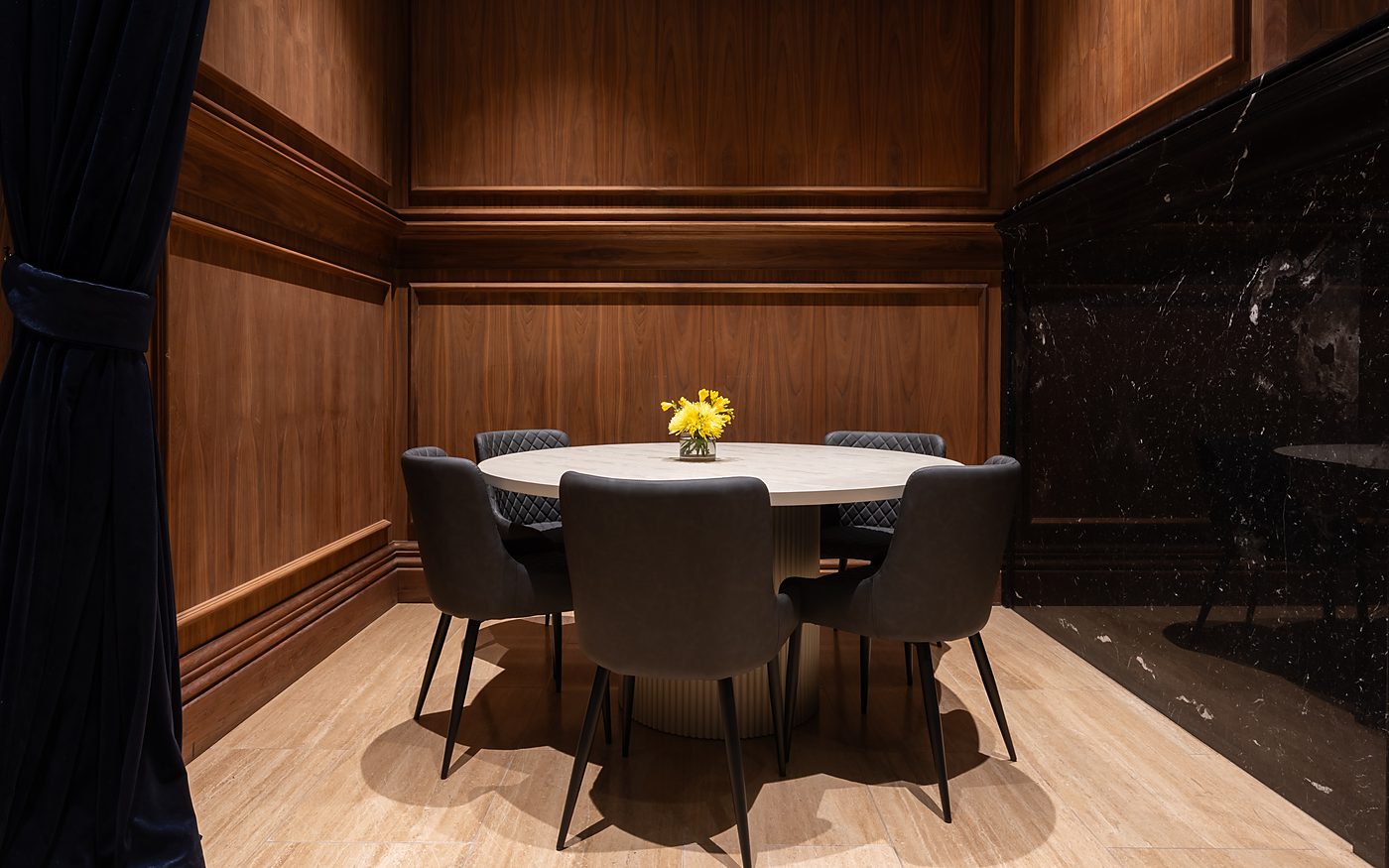A round table for six in the timber-panelled corner